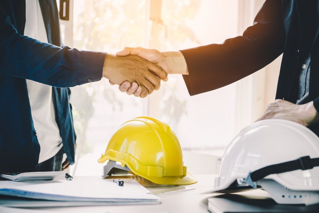 businessman shaking hands with contractor