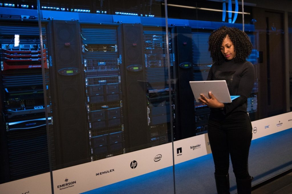 woman next to some machines